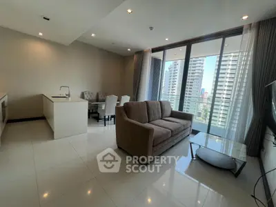 Modern open-plan living room with kitchen and city view balcony