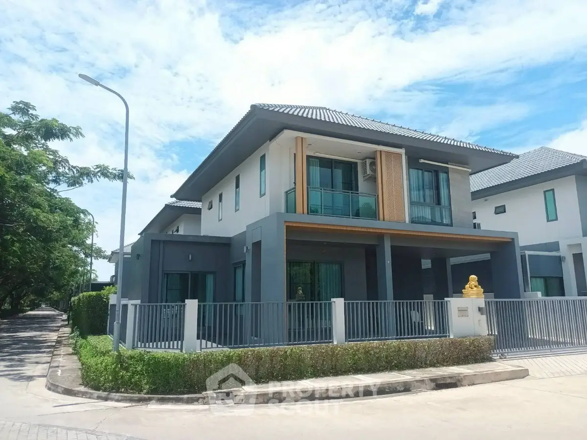 Modern two-story house with sleek design and spacious balcony in a serene neighborhood.