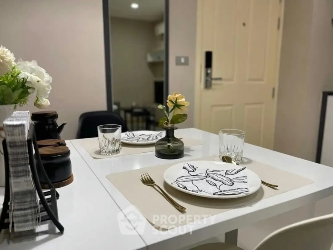 Chic dining setup in modern apartment with elegant tableware and cozy ambiance.