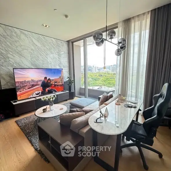 Luxurious living room with modern decor and stunning city view, featuring a large TV and elegant furnishings.