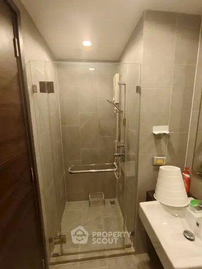 Modern bathroom with glass shower enclosure and sleek fixtures