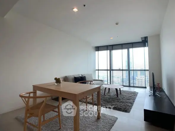 Modern living room with city view, minimalist furniture, and large windows.