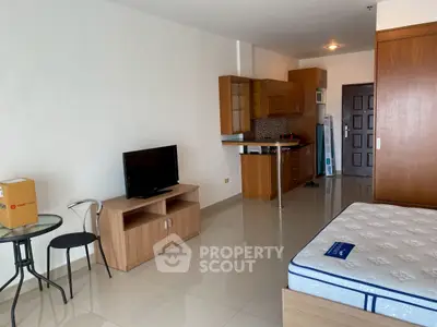 Spacious studio apartment with modern kitchen and cozy living area, perfect for urban living.