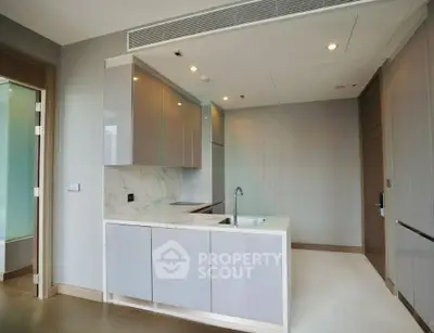 Modern kitchen with sleek cabinetry and marble countertops in a contemporary apartment.