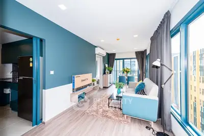 Modern living room with stylish decor and large windows for natural light.