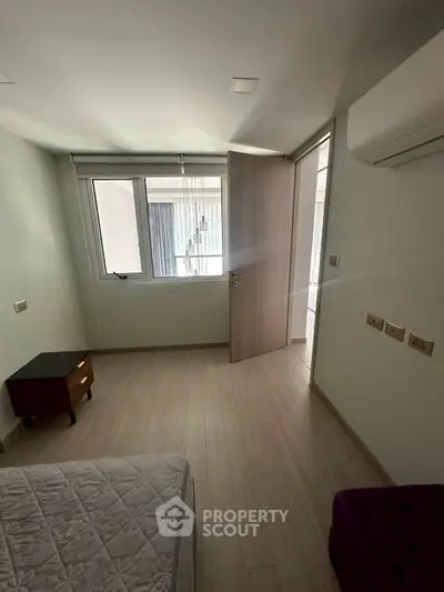 Spacious bedroom with modern air conditioning and natural light