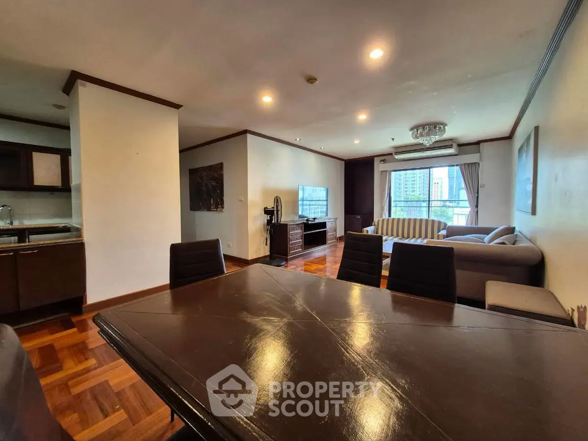 Spacious living room with elegant dining area and city view, perfect for modern urban living.