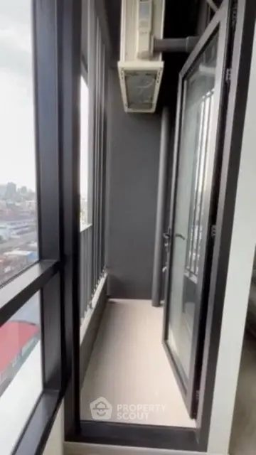 Modern narrow balcony with city view and glass door access