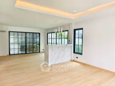 Spacious modern living room with elegant marble island and large windows