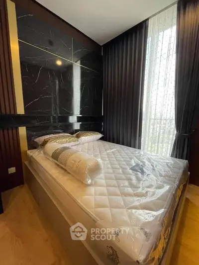 Luxurious bedroom with modern design and floor-to-ceiling windows for natural light.