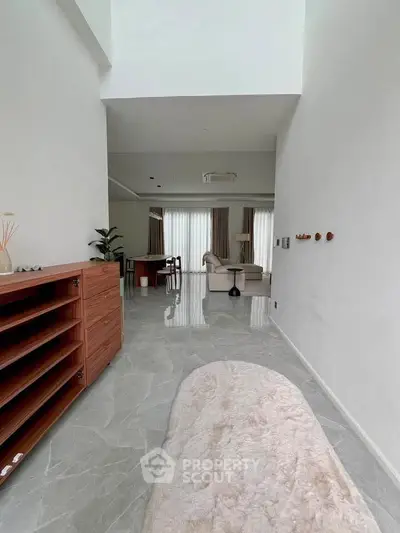 Spacious modern living room with elegant decor and large windows for natural light.