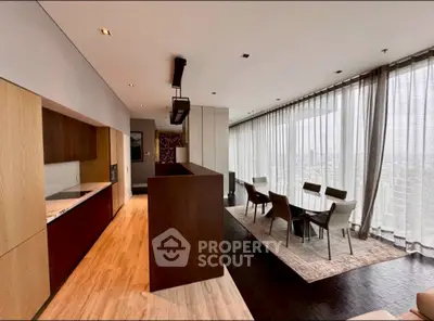 Luxurious open-plan living and dining area with panoramic city views and modern kitchen.