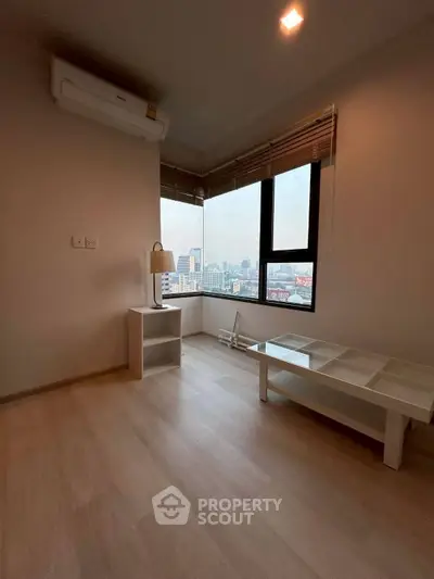 Spacious corner unit with city view, featuring modern flooring and ample natural light.