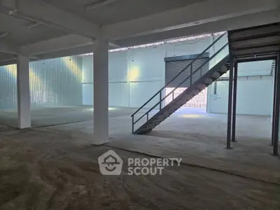 Spacious industrial warehouse with mezzanine and ample natural light