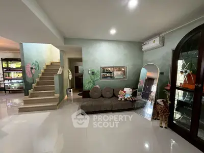 Spacious living room with modern decor and plush sofa, perfect for family gatherings.