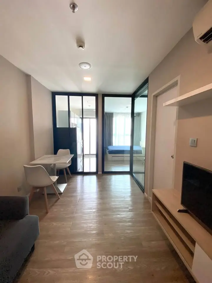 Modern apartment interior with open layout, featuring a cozy living area and stylish furnishings.