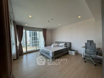 Spacious bedroom with city view and modern furnishings in high-rise apartment