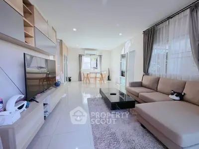 Spacious modern living room with sleek furniture and abundant natural light