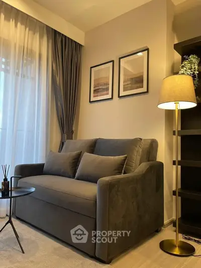 Cozy living room with elegant sofa and floor lamp, perfect for relaxation.