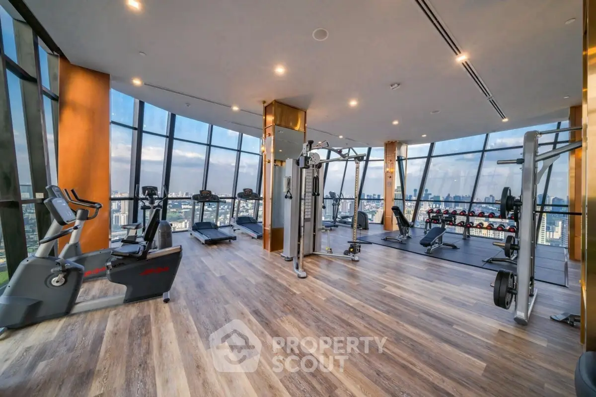 Luxurious high-rise gym with panoramic city views and modern fitness equipment.