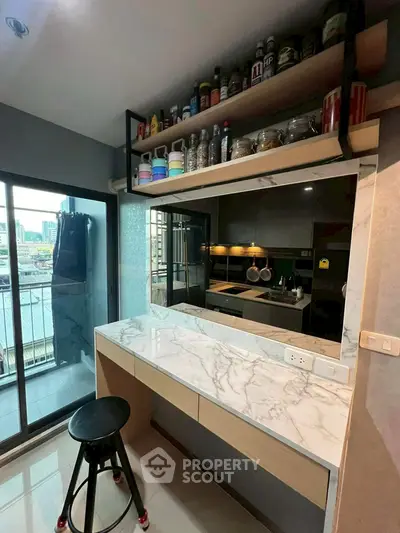 Modern kitchen with marble countertop and open shelving, city view from balcony.