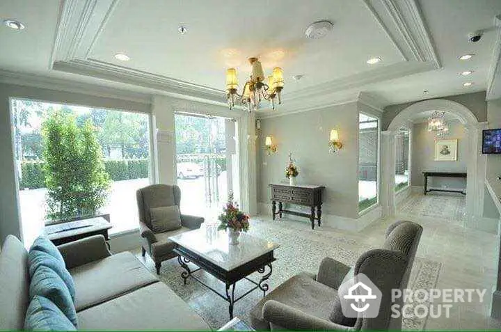 Elegant living room with plush seating and large windows offering natural light.