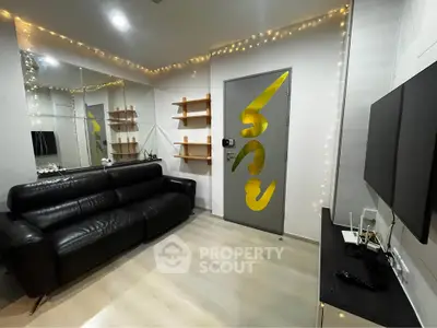 Modern living room with sleek black sofa, wall-mounted TV, and decorative shelves