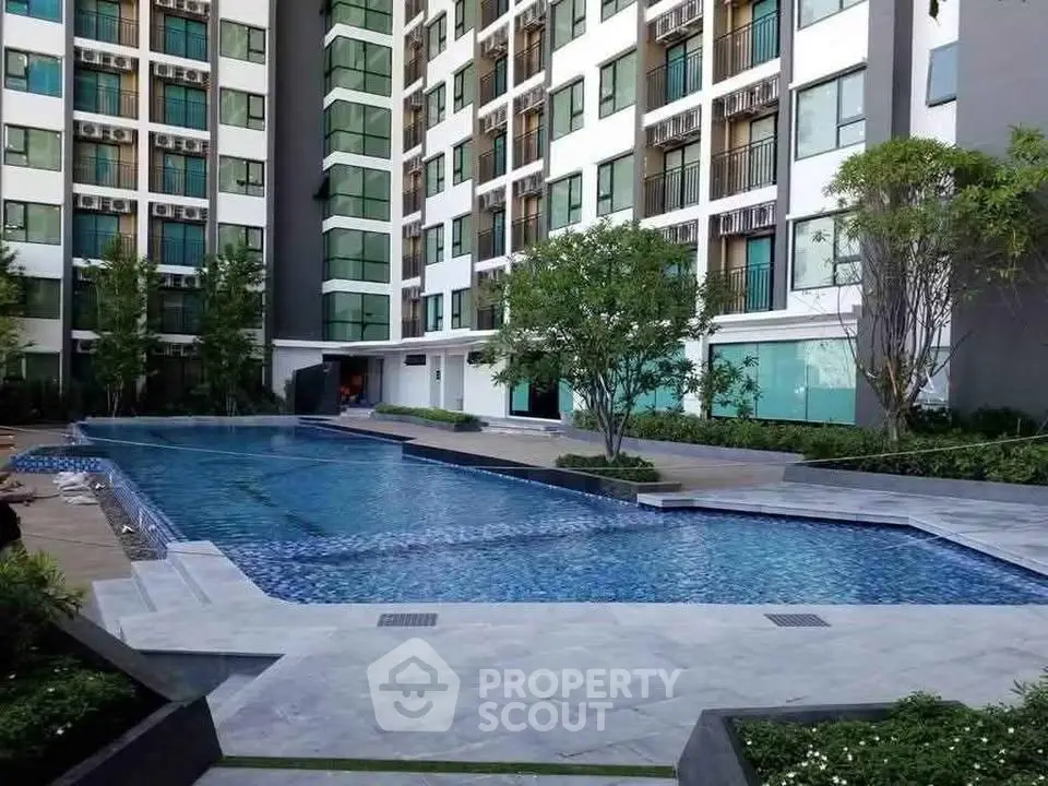 Luxurious apartment complex with stunning outdoor pool and modern architecture.