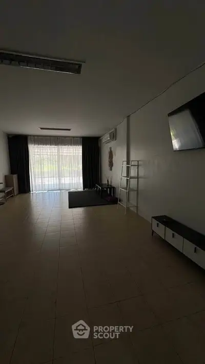 Spacious living room with large window and modern decor