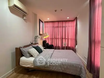 Cozy bedroom with modern decor and large window with pink curtains