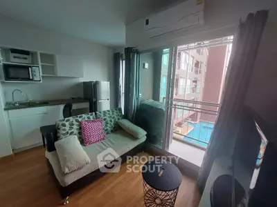 Modern living room with balcony overlooking pool in stylish apartment