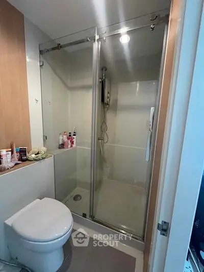 Modern bathroom with glass shower enclosure and sleek fixtures