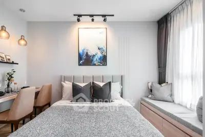 Modern bedroom with stylish decor, cozy seating nook, and elegant lighting.
