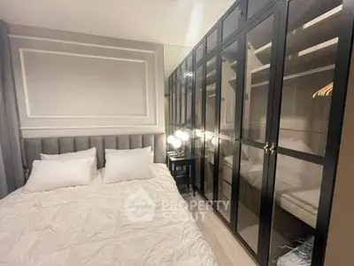 Luxurious bedroom with elegant mirrored wardrobe and plush bedding