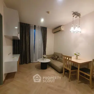 Cozy living room with modern decor and dining area in a stylish apartment.