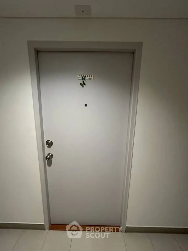 Modern apartment entrance door with sleek design and secure locking system.