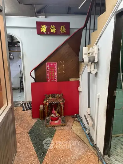Unique interior space with traditional decor and staircase, showcasing cultural charm and character.