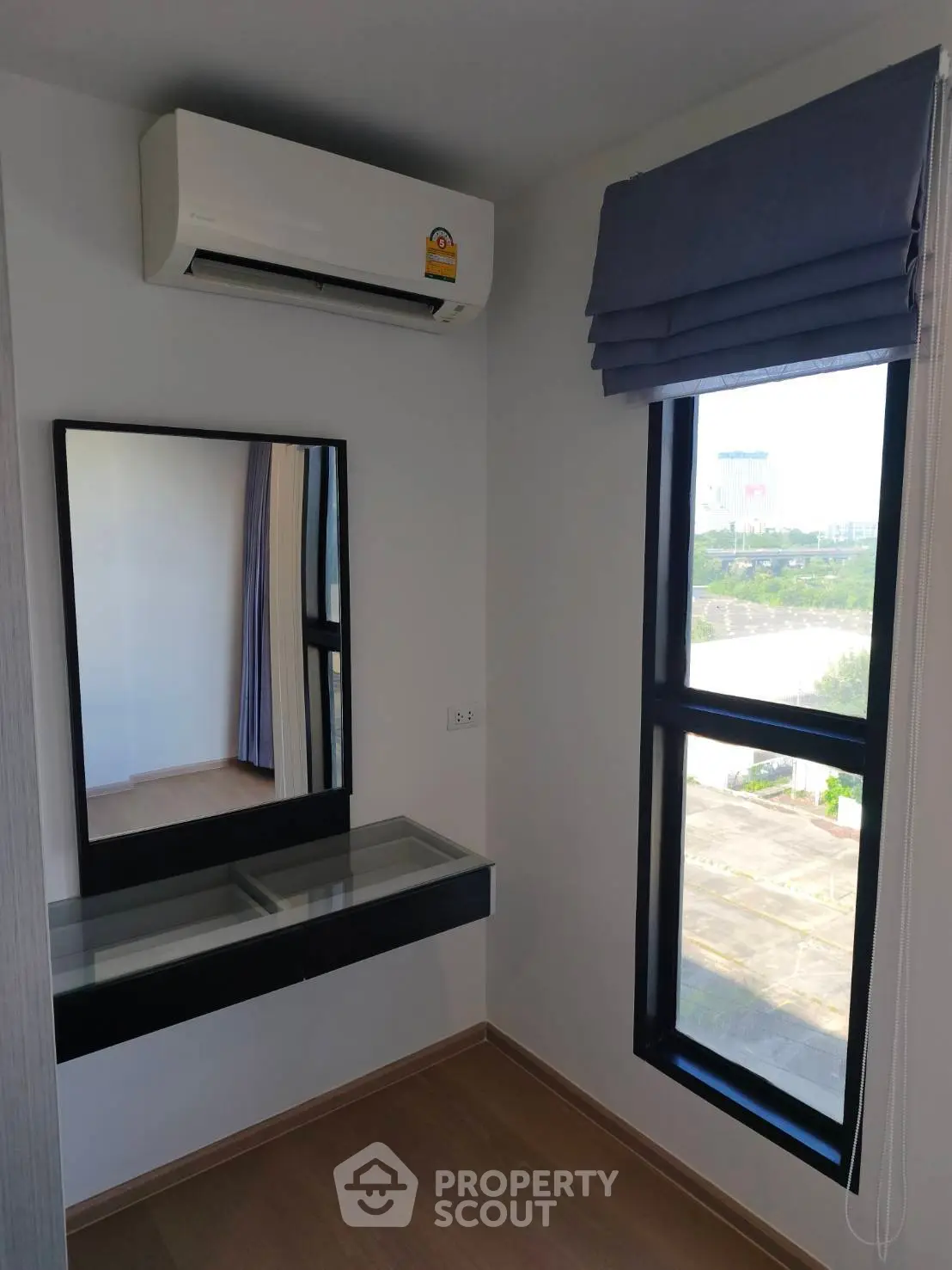 Modern bedroom corner with air conditioning and large window view