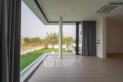 Spacious modern living room with large windows and garden view