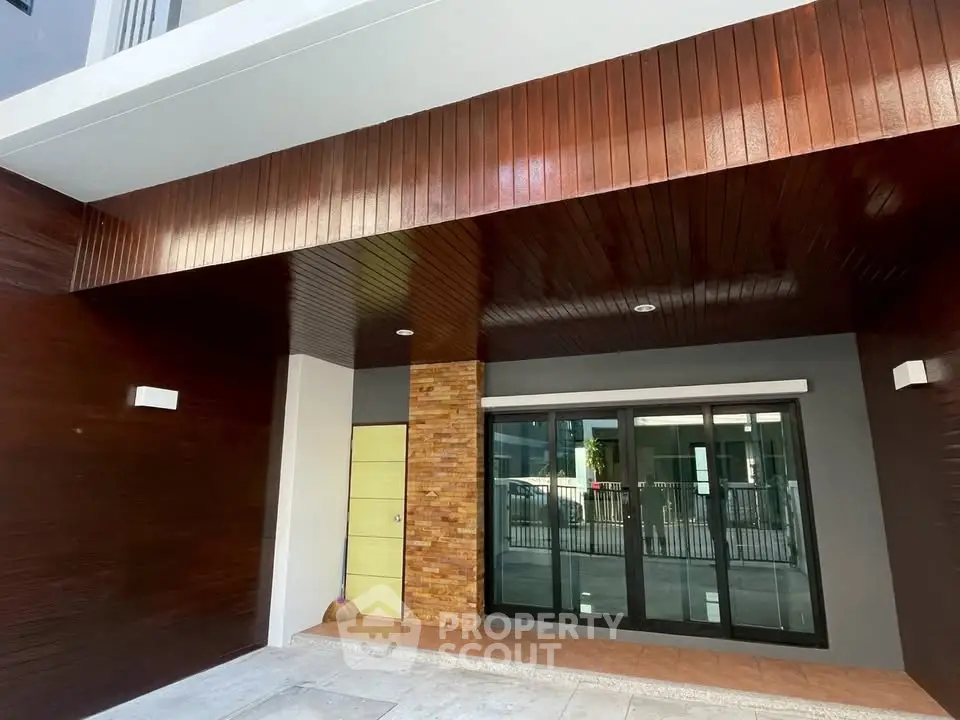 Modern building entrance with sleek wooden paneling and glass doors