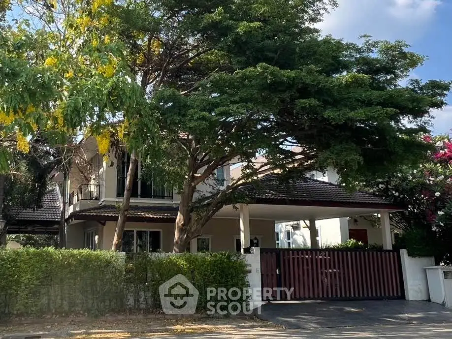 Charming suburban house with lush greenery and spacious driveway, perfect for family living.
