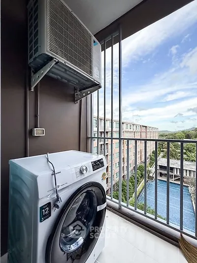 Modern balcony with washing machine and scenic view of pool and greenery, perfect for urban living.