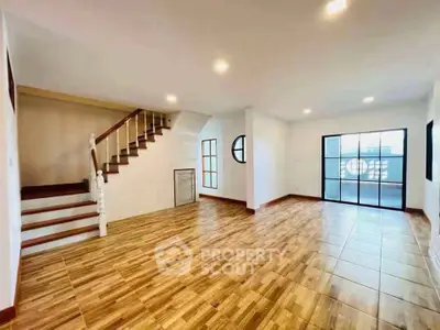 Spacious living room with wooden flooring and staircase in modern home