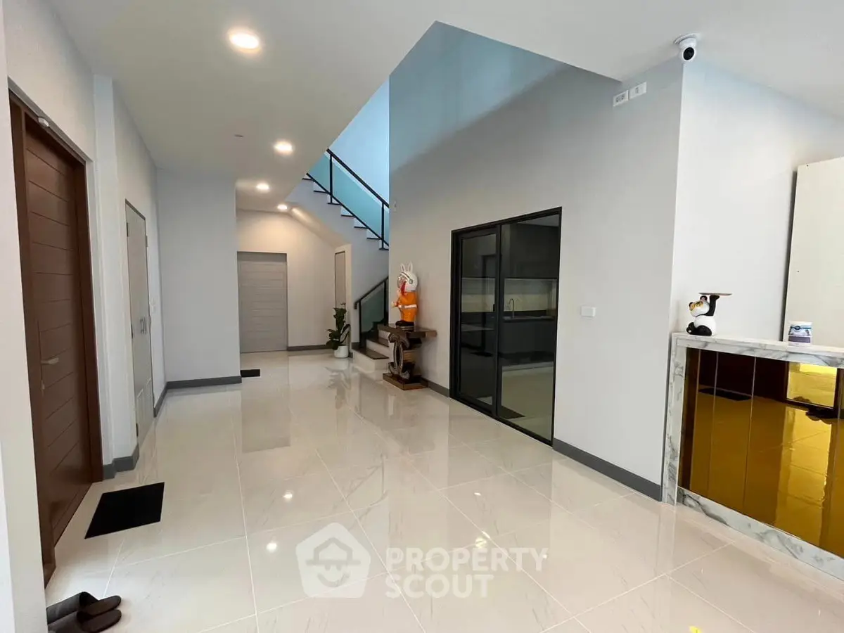 Spacious modern entrance with sleek design and glossy tiled flooring