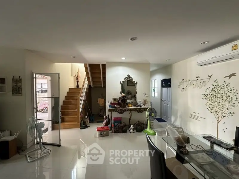 Spacious living room with modern decor and staircase in a bright home