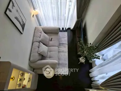 Modern living room with cozy sofa, elegant curtains, and stylish decor in a contemporary apartment.