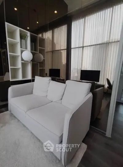 Modern living room with sleek design and cozy sofa, perfect for relaxation and entertainment.