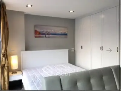 Modern bedroom with white wardrobe and cozy lighting in stylish apartment
