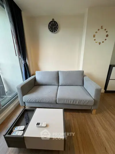 Modern living room with stylish gray sofa and sleek coffee table, perfect for urban living.