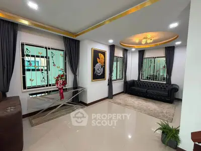 Elegant living room with modern decor, plush seating, and stylish lighting in a luxurious home.